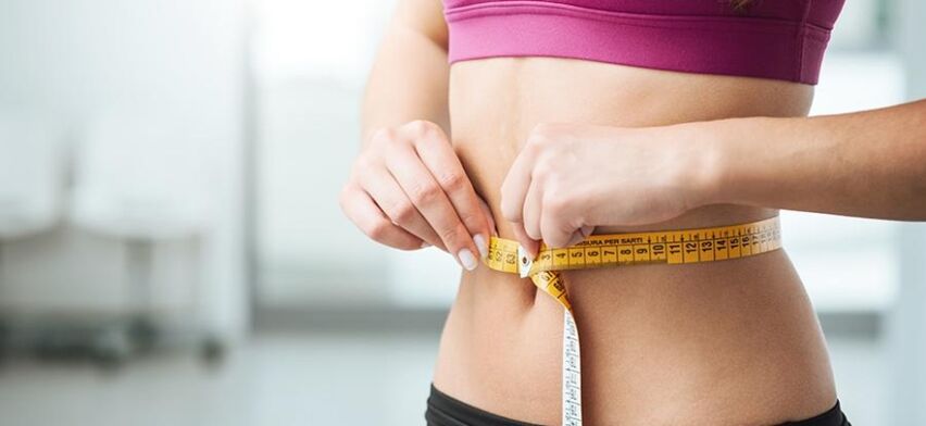 Girl measuring waist